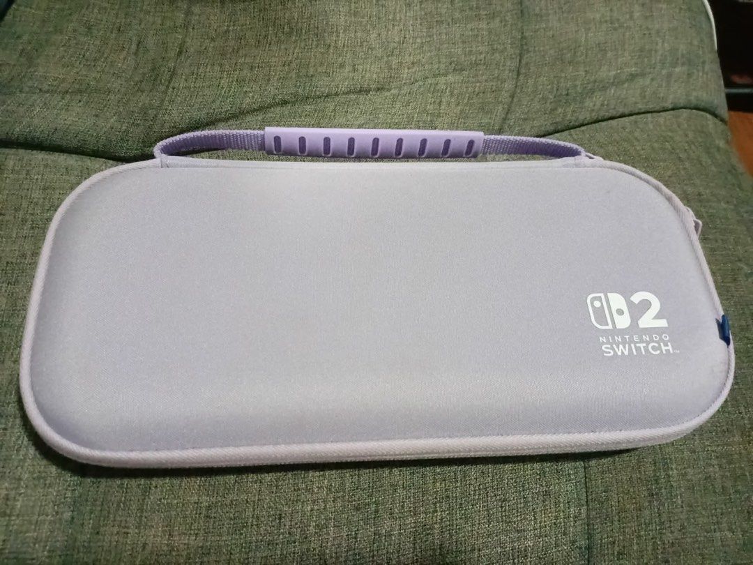 Nintendo Switch 2 Case (Category: Cases & Covers) located in Los Banos. Submitted by acgalamgam (Listing ID 1439510305, Image 1). Description: - Light purple exterior with matching handle - Black interior - Mesh pocket and elastic straps for game cartridges - Zipper closure - Nintendo Switch logo on the front Payment via gcash or BPI online. Shipping via JT or LBC express. Meet up within Los Banos or nearby areas. .