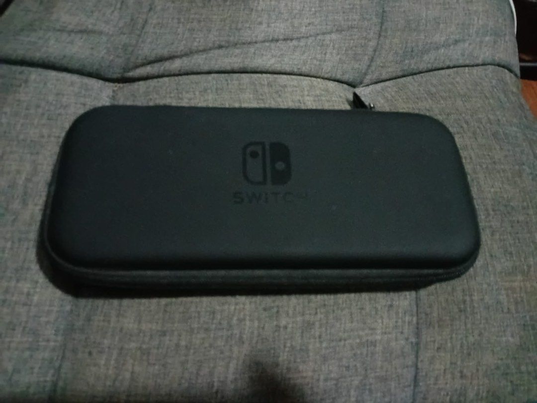 Nintendo Switch Lite Carrying Case (Category: Cases & Covers) located in Los Banos. Submitted by acgalamgam (Listing ID 1439510869, Image 1). Description: - Black carrying case for Nintendo Switch Lite. - Features a secure zipper closure. - Includes a convenient carrying handle. - Interior has a compartment for the console. - Mesh pocket for accessories. - Slots to hold game cartridges. - Protects your Switch Lite during travel and storage. Payme