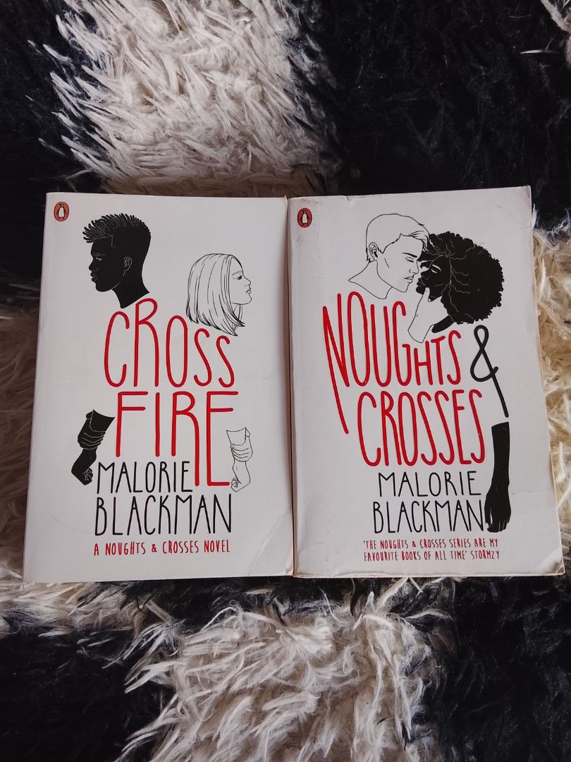Noughts & Crosses Series by Malorie Blackman (Category: Storybooks) located in Manila. Submitted by cycy_books (Listing ID 1439572303, Image 1). Description: With free mmpb book for every purchase - Set of two books: "Noughts & Crosses" and "Cross Fire". - Both are paperback editions. - Author: Malorie Blackman. - Cover art features people. - Titles are in red..