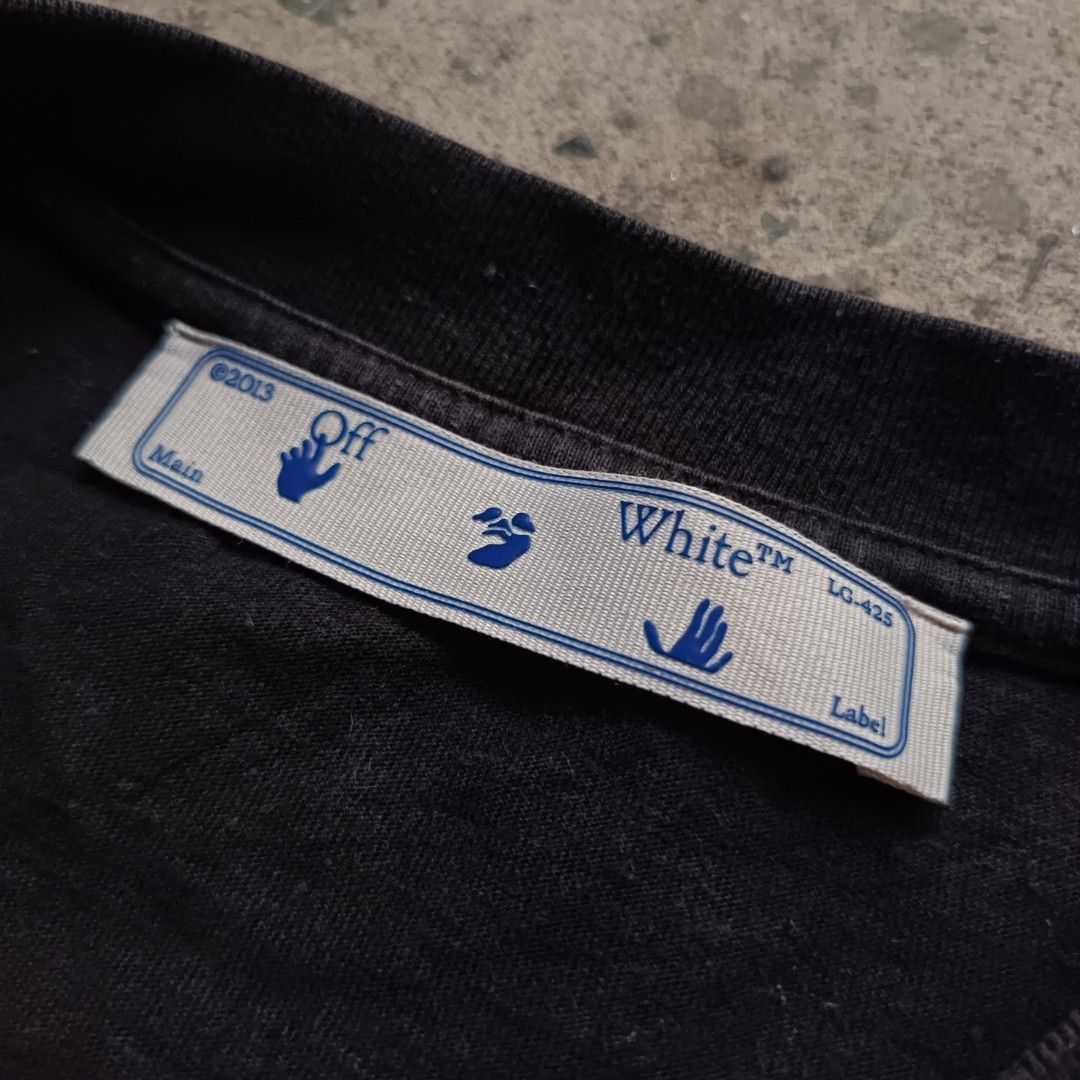 Off-White Black T-Shirt (Category: Tshirts & Polo Shirts ) located in Caloocan City. Submitted by gemfinder669 (Listing ID 1439524422, Image 3). Description: - Authentic Off-White T-shirt - Color: Black - Features red logo (front and back) - Iconic arrow design on the back - Includes Off-White label and "FOR THE NATURE" tag - Made in Milan Measurements: 23' width 30.5' length •Color rate: 9/10 •Condition: Verygood •Issue: Hairlines 900.