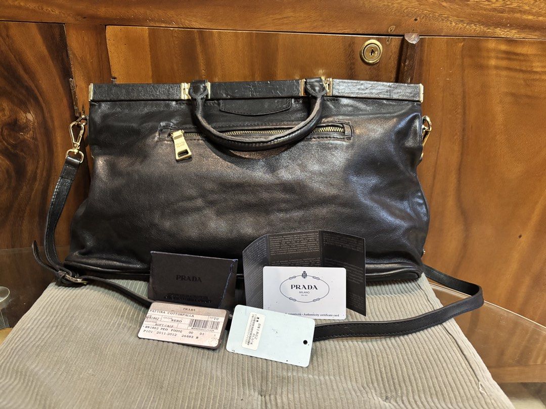Original Prada Black Leather Two Way bag (Category: Luxury Bags & Wallets) located in Imus. Submitted by bagsofblessings24 (Listing ID 1439510260, Image 1). Description: Preloved Original Prada Nero Soft Calf leather bag with Certificate of authenticity from Prada Two way medium to large Very good condition Original strap Gold hardwares with lock, missing key Exterior flaw - a little bended on handle and small pressed mark on the lips Interior fl
