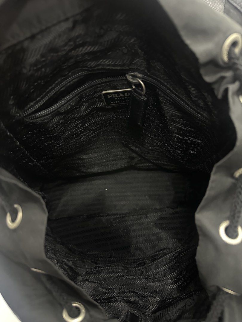 Prada Black Nylon Backpack (Category: Luxury Bags & Wallets) located in Baguio. Submitted by luxukayukay (Listing ID 1439596291, Image 2). Description: - Authentic Prada backpack - Color: Black - Material: Nylon - Features: - Drawstring closure - Two front pockets - Adjustable shoulder straps - Interior: - Zippered pocket - Prada logo tag - Zipper pull: 'LAMPO' - Made in Italy.