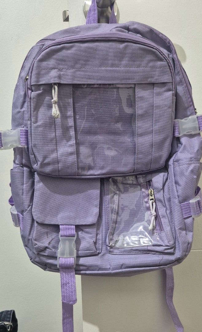 Purple Backpack with Multiple Pockets (Category: Backpacks) located in Mandaluyong City. Submitted by lauracmendoza (Listing ID 1439547170, Image 3). Description: - Purple backpack - Multiple pockets and compartments for organized storage - Adjustable straps and buckles - Main compartment and smaller pockets with clear windows - Durable, textured material - Padded straps for comfort.