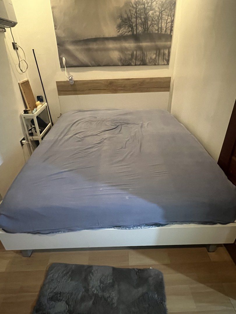 Queen Size Bed Frame with Headboard and mattress (Category: Bed Frames & Mattresses) located in Manila. Submitted by adrianojr56673 (Listing ID 1439540541, Image 1). Description: - Queen-size bed frame plus mattress - White color headboard - Features a headboard with wooden accent - Bed frame height: approximately 16 inches - Shown with a blue bedsheet (bedsheet not included) - Bed frame and mattress (12” uratex premium) -bring your own carpenter