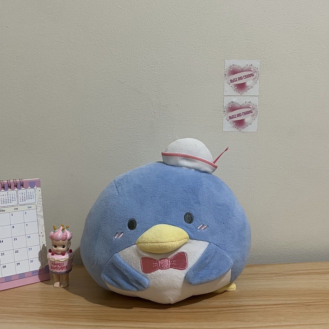Sanrio Tuxedo Sam Plush Toy (Category: Plushies & Soft Toys) located in Taytay. Submitted by blitzncharms (Listing ID 1439556154, Image 1). Description: - Adorable Tuxedo Sam plush toy. - Features a blue body, yellow beak, and a cute bow tie. - Comes with a sailor hat. - 2022 Sanrio product. - Made in China. - Perfect for Sanrio fans and collectors!.