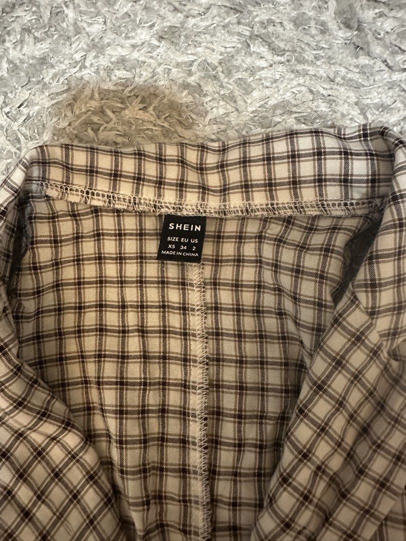 SHEIN Plaid Dress (Category: Dresses) located in Magalang. Submitted by oohgabby (Listing ID 1439526816, Image 2). Description: - SHEIN Plaid Dress - Size: S - Design: Button-down - Sleeveless - Features: Collared neckline - Color: Neutral - Perfect for various occasions!.