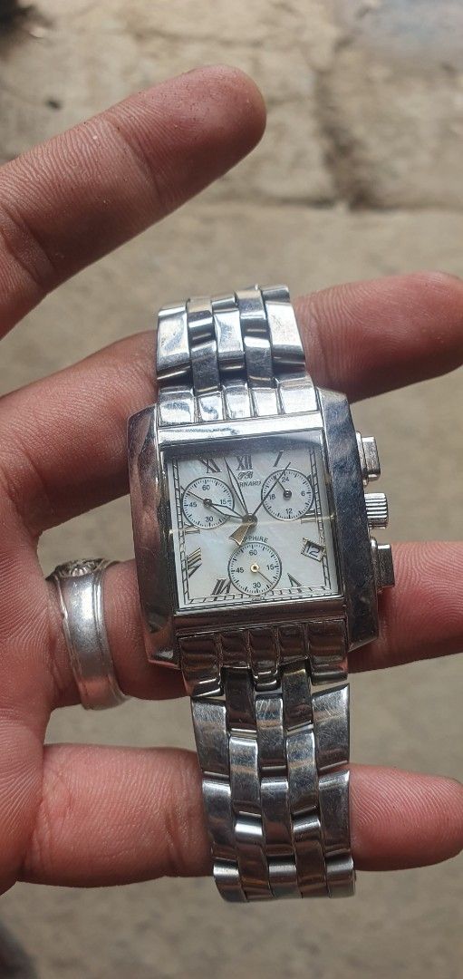 Silver Chronograph Watch (Category: Men's Watches) located in Zamboanga. Submitted by sarahjaneatari (Listing ID 1439458794, Image 1). Description: - Silver rectangular watch - Roman numeral hour markers - Features three sub-dials - Silver bracelet-style band - Chronograph function - Metal construction - Engraved details on the back.