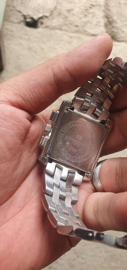 Silver Chronograph Watch (Category: Men's Watches) located in Zamboanga. Submitted by sarahjaneatari (Listing ID 1439458794, Image 2). Description: - Silver rectangular watch - Roman numeral hour markers - Features three sub-dials - Silver bracelet-style band - Chronograph function - Metal construction - Engraved details on the back.