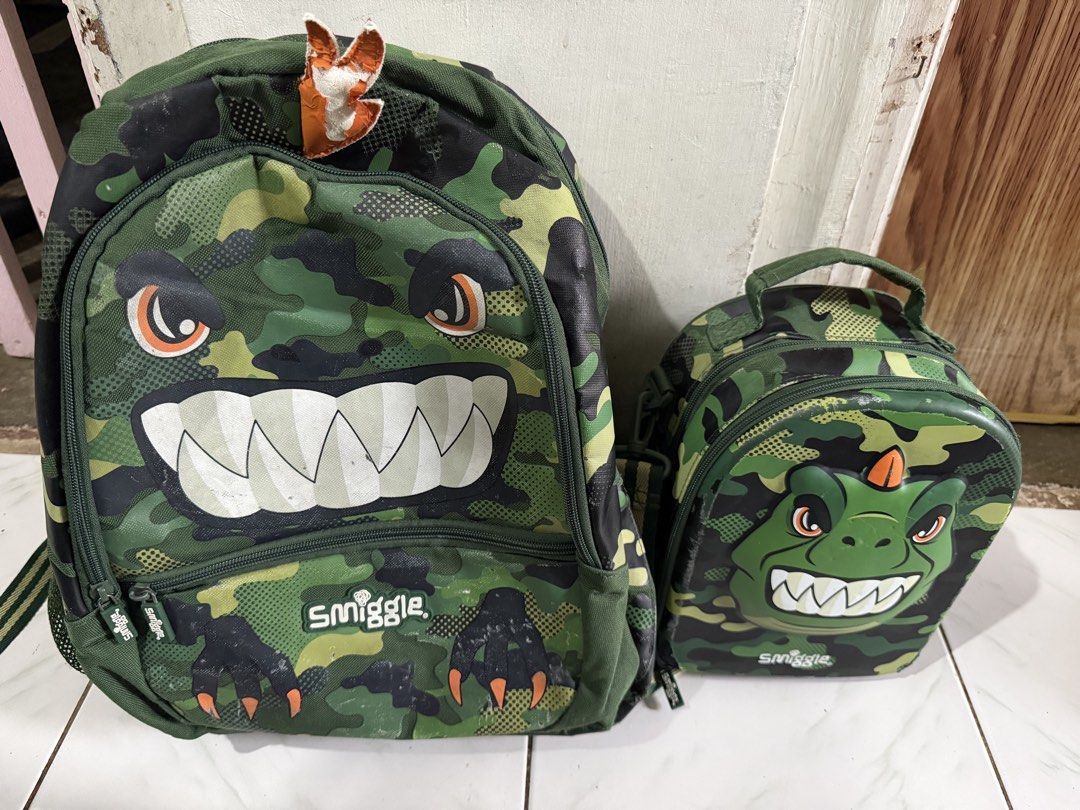 Smiggle Camouflage Backpack and Lunch Bag Set (Category: Babies & Kids Fashion) located in Makati City. Submitted by gkp14 (Listing ID 1439519742, Image 1). Description: - Smiggle Camouflage Monster Backpack & Lunch Bag Set - Backpack features: - Large main compartment - Front pocket - Lunch bag with handle - Durable material - Ideal for school and travel.