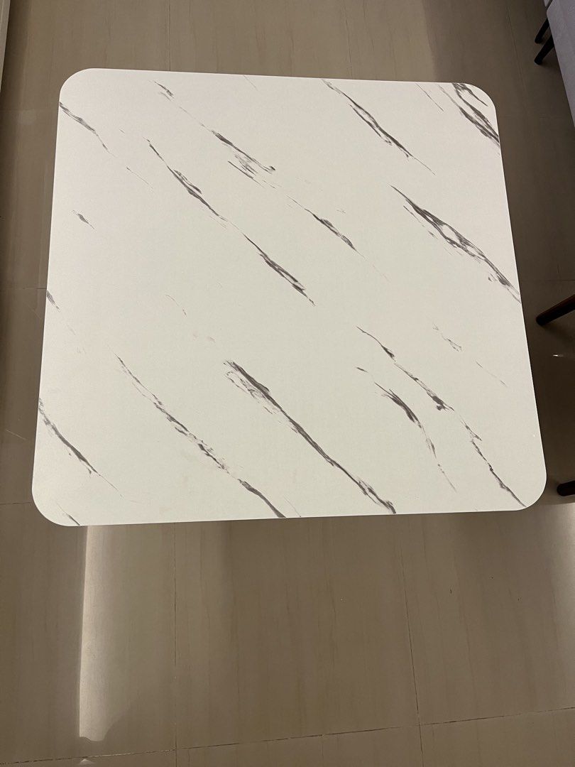 Square Table (Category: Tables & Sets) located in Singapore. Submitted by maxxfong (Listing ID 1439535045, Image 1). Description: - Square marble-look table with white surface and grey veining. - Sleek, modern design. - Ideal for small spaces or as an accent set..