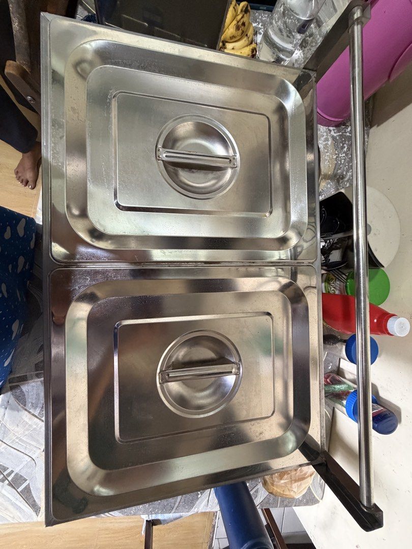 Stainless Steel Deep Fryer (Category: Food Organization & Storage) located in Caloocan City. Submitted by avlossoms.ph (Listing ID 1439459192, Image 3). Description: - Original Price: P3,600 - Pwede I-test - Stainless steel food warmer - Two compartments with individual lids - Includes two wire baskets - Comes with a set of tongs - Features a side rack for extra storage - Designed for commercial use - Ideal for keeping food warm.