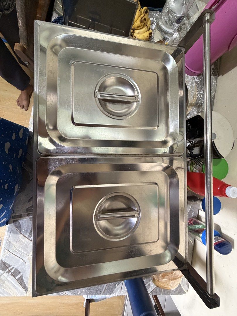 Stainless Steel Deep Fryer (Category: Food Organization & Storage) located in Caloocan City. Submitted by avlossoms.ph (Listing ID 1439459192, Image 2). Description: - Original Price: P3,600 - Pwede I-test - Stainless steel food warmer - Two compartments with individual lids - Includes two wire baskets - Comes with a set of tongs - Features a side rack for extra storage - Designed for commercial use - Ideal for keeping food warm.
