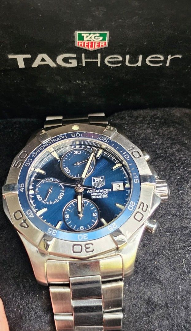 TAG Heuer Aquaracer Automatic Chronograph Watch (Category: Men's Watches) located in Manila. Submitted by watchphil (Listing ID 1439510280, Image 3). Description: - Authentic TAG Heuer Aquaracer - Caliber 16 - 41mm - Automatic chronograph watch - Blue dial - Stainless steel case and bracelet - Date display - Includes original box and papers - Diver's helmet design on case back - Model number: CAF2112 55k Negotiable.