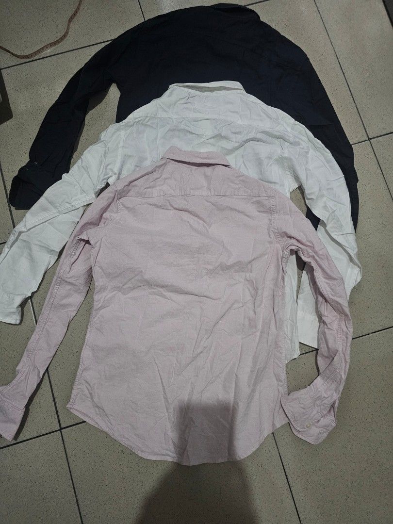 Uniqlo Long Sleeve Shirts (Category: Coats, Jackets and Outerwear) located in Marikina City. Submitted by charmaine185845 (Listing ID 1439523454, Image 2). Description: - Set of three Uniqlo long sleeve shirts - Colors: Navy blue and White (Ines De La Fressange) and Pink Oxford - Features button-down closures and collared necks - Pink : Medium - White and Navy Blue : Small.
