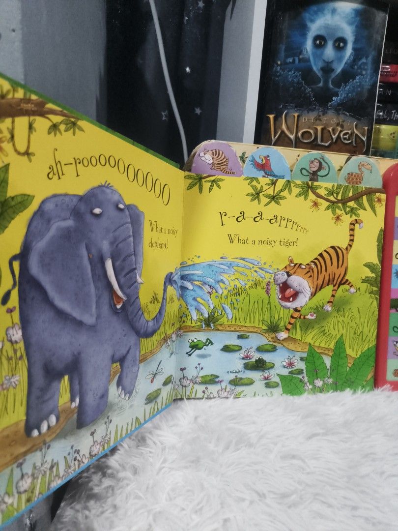 Usborne Noisy Jungle Sound Book (Category: Children's Books) located in Cabuyao City. Submitted by chaptersandwonders143 (Listing ID 1439517196, Image 2). Description: Untested but with battery slot - Usborne Noisy Jungle sound book - Features vibrant illustrations. - Includes animal sounds: elephant, tiger, monkey, and crocodile. - Designed for young children. - Illustrated by Lee Wildish. - Sound module with easy-to-press buttons..