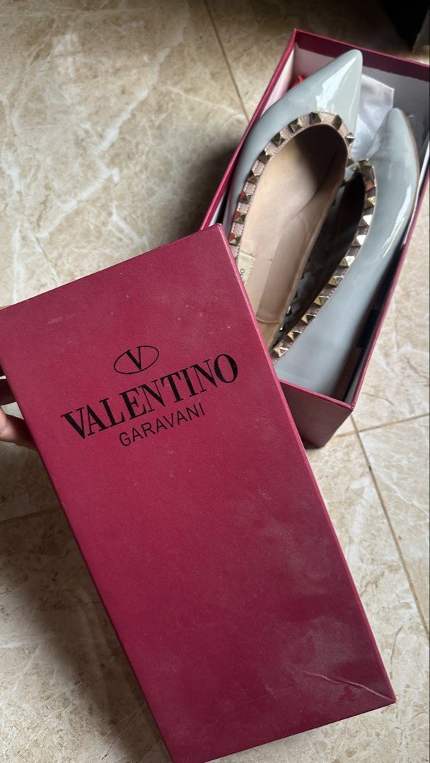 Valentino Garavani Rockstud Flats (Category: Flats & Sandals) located in Pateros City. Submitted by waiteetee (Listing ID 1439422715, Image 2). Description: DUPE Used once - Valentino Garavani Rockstud flats - Light grey color - Signature gold-tone Rockstud embellishments - Comes with Valentino box - Pointed toe design - Low heel - Light pink interior.