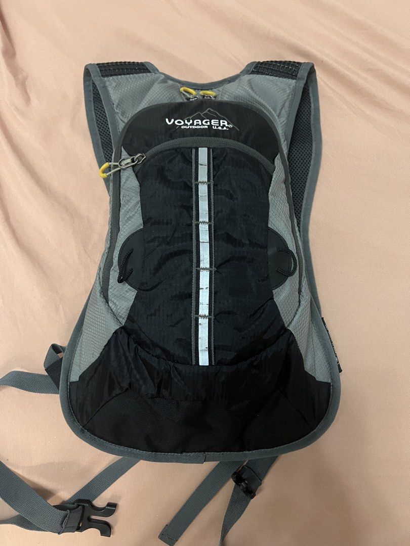 Voyager Outdoor Hydration Backpack (Category: Backpacks) located in Manila. Submitted by householdmama (Listing ID 1439502951, Image 2). Description: - Voyager Outdoor hydration backpack, perfect for outdoor activities. - Stylish black and gray color scheme. - Enhanced visibility with a reflective strip. - Adjustable straps for a custom fit. - Multiple compartments for organized storage. - Breathable mesh back panel for comfort. - Secure waist st