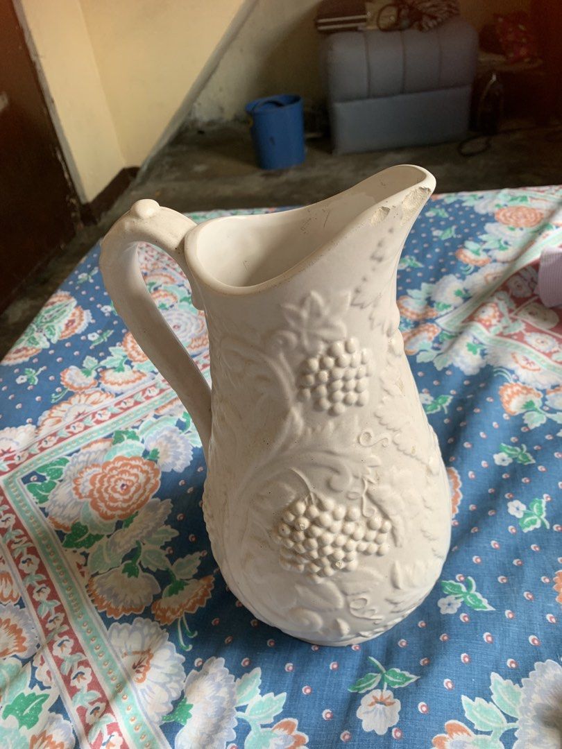 1970s Antique White Ceramic Pitcher with Grapevine Design (Category: Pitchers & Dispensers) located in Pasig City. Submitted by norman2828 (Listing ID 1439444902, Image 3). Description: - Antique Pitcher Ceramic -Elegant white ceramic pitcher featuring a grapevine design. - Not sure if Ivory Ceramic.