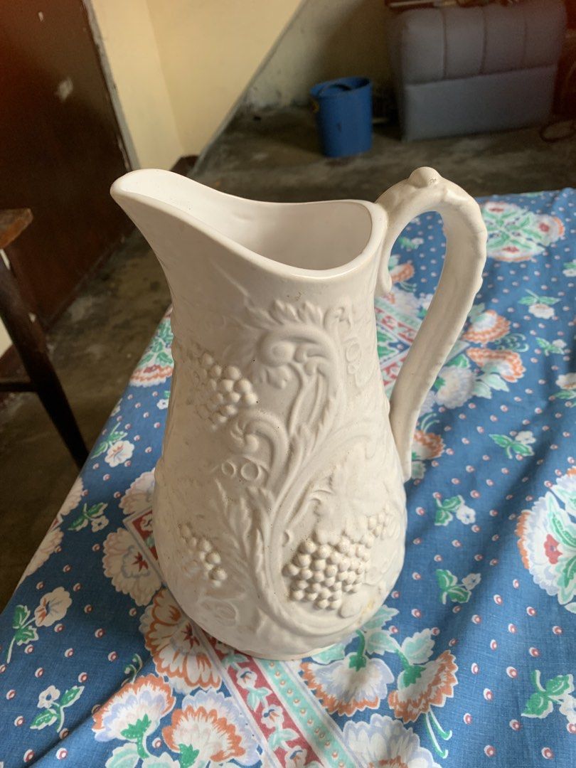 1970s Antique White Ceramic Pitcher with Grapevine Design (Category: Pitchers & Dispensers) located in Pasig City. Submitted by norman2828 (Listing ID 1439444902, Image 2). Description: - Antique Pitcher Ceramic -Elegant white ceramic pitcher featuring a grapevine design. - Not sure if Ivory Ceramic.
