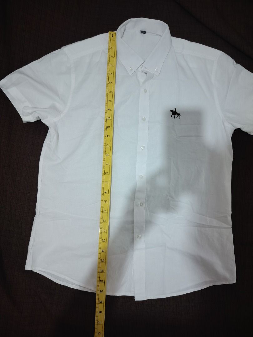White Short Sleeve Polo Shirt (Category: Tshirts & Polo Shirts ) located in Cebu City. Submitted by bravetree.3f281d (Listing ID 1439459838, Image 1). Description: - White short sleeve polo shirt - Small embroidered logo - Button-down collar - Chest pocket - Lightweight fabric - Measurements in photos - Perfect for casual wear.
