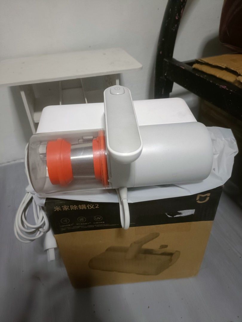 Xiaomi Mijia 2 Handheld Vacuum Cleaner (Category: Vacuum Cleaner & Housekeeping) located in Manila. Submitted by lilyappliance (Listing ID 1439600947, Image 1). Description: - New Xiaomi Mijia 2 handheld vacuum cleaner. - Color: White with orange accents. - Features a transparent dust cup. - Ergonomic handle for easy use. - Comes with the original box, which includes an image of the vacuum and Chinese characters..