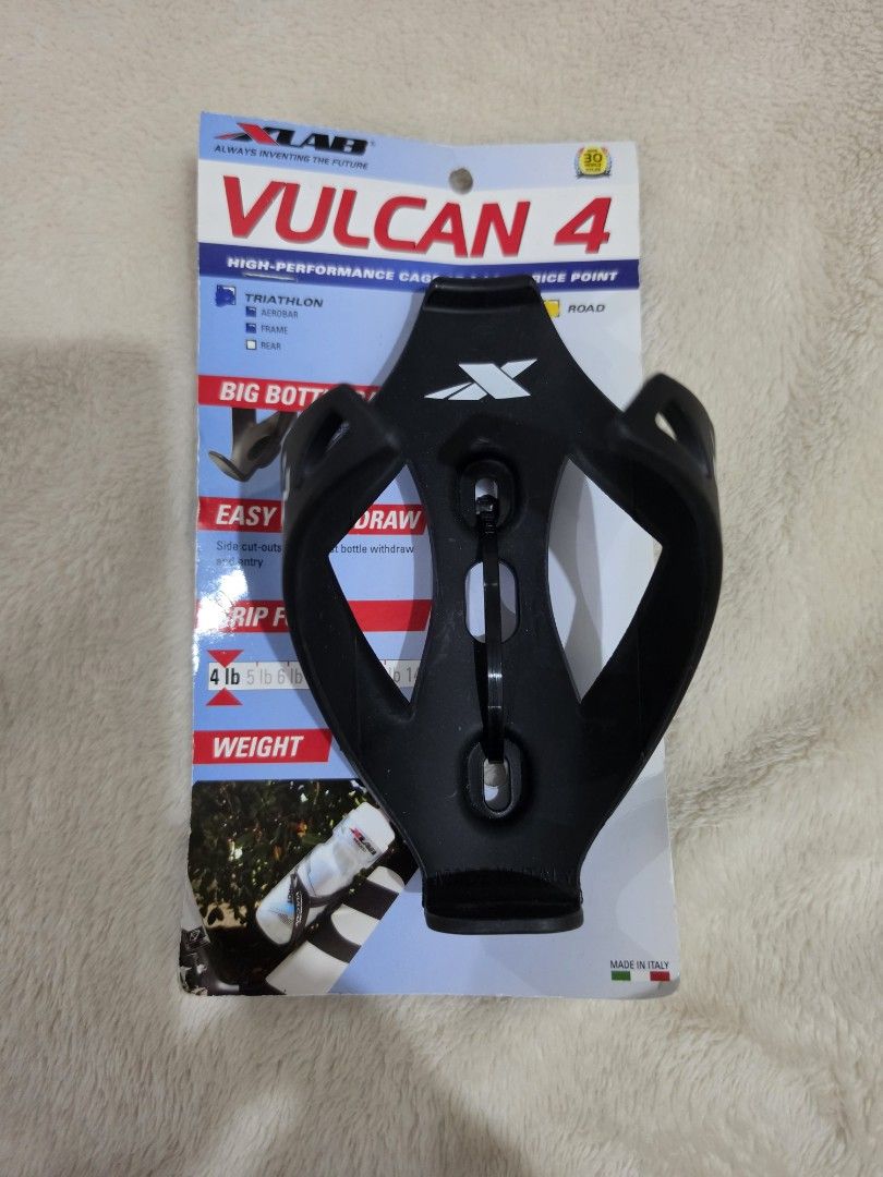 XLAB Vulcan 4 Water Bottle Cage (Category: Bicycles) located in Paranaque City. Submitted by krisfuentes (Listing ID 1439554740, Image 1). Description: - XLAB Vulcan 4 - Designed for high-performance cycling - Features: - Big bottom draw - Easy grip - Holds up to 4 lbs - Color: Black with white XLAB branding - Condition: New, with original packaging.