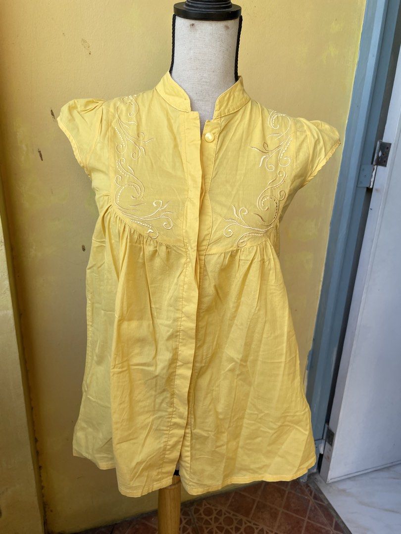 Yellow Embroidered Blouse (Category: Blouses) located in Pasig City. Submitted by khaleisi (Listing ID 1439502491, Image 1). Description: - Yellow blouse - Mandarin collar - Button-down front - Embroidered detailing - Short sleeves - Tie-waist back - Lightweight fabric - Suitable for warm weather - Simple and elegant - Bust 36” length 25”.