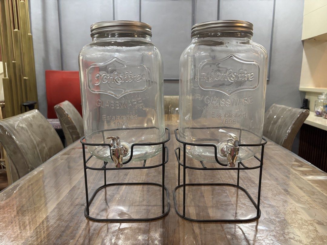 Yorkshire Glassware Drink Dispenser with Stand (Category: Pitchers & Dispensers) located in Mandaluyong City. Submitted by carol_0368 (Listing ID 1439452409, Image 2). Description: - Set of two Yorkshire Glassware drink dispensers. - Includes metal stands. - Each dispenser has a silver lid and spigot. - Classic design with "Yorkshire Glassware" logo. - Ideal for parties and everyday use. -8 L capacity -with metal stand -used only during gender re