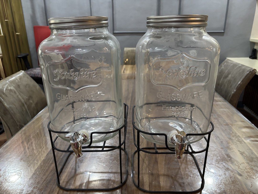 Yorkshire Glassware Drink Dispenser with Stand (Category: Pitchers & Dispensers) located in Mandaluyong City. Submitted by carol_0368 (Listing ID 1439452409, Image 1). Description: - Set of two Yorkshire Glassware drink dispensers. - Includes metal stands. - Each dispenser has a silver lid and spigot. - Classic design with "Yorkshire Glassware" logo. - Ideal for parties and everyday use. -8 L capacity -with metal stand -used only during gender re