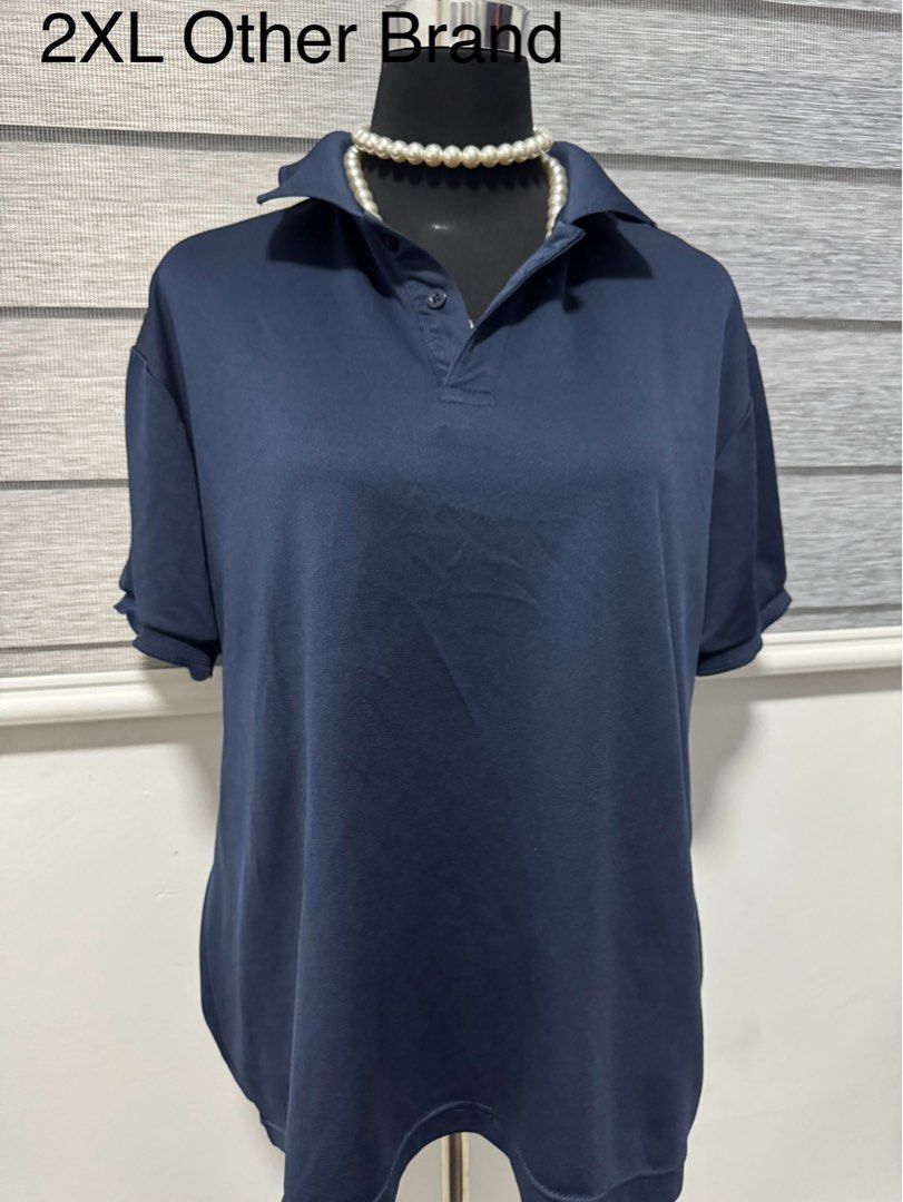 2XL Navy Blue Polo Shirt (Category: Tshirts & Polo Shirts ) located in Manila. Submitted by chonkycloset (Listing ID 1439743398, Image 1). Description: - Navy blue polo shirt - Size: 2XL - Features a collared neckline - Short sleeves - Button closure - Relaxed fit - Made of smooth, possibly synthetic fabric.