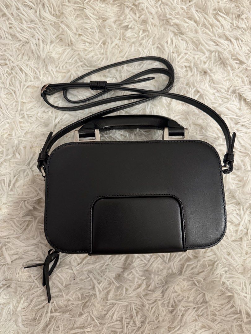 AMI Alexandre Mattiussi Black Handbag (Category: Luxury Bags & Wallets) located in San Pedro. Submitted by julio_sibulo (Listing ID 1439789062, Image 2). Description: - AMI Alexandre Mattiussi black handbag - Top handle and detachable shoulder strap - Front pocket with AMI logo - Clean interior - Rectangular shape, structured design - Silver-toned hardware.