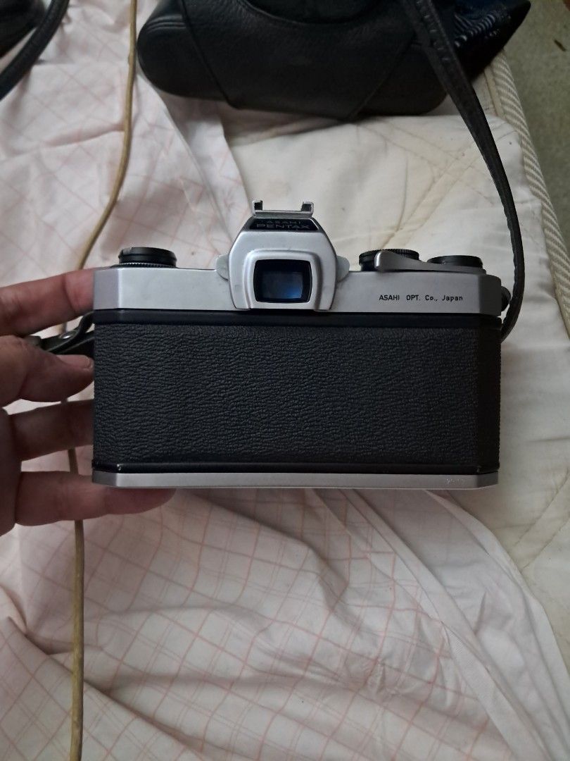 Asahi Pentax SP Film Camera (Category: Cameras) located in Davao. Submitted by rbjuvyreyn18879 (Listing ID 1439803562, Image 1). Description: - Vintage Asahi Pentax SP film camera - Silver and black body - Includes lens and camera strap - Comes with a camera case - Features aperture and focus markings on the lens - Top dial for shutter speed - Light meter dial included.