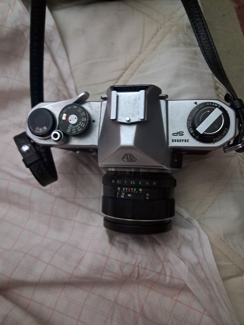 Asahi Pentax SP Film Camera (Category: Cameras) located in Davao. Submitted by rbjuvyreyn18879 (Listing ID 1439803562, Image 3). Description: - Vintage Asahi Pentax SP film camera - Silver and black body - Includes lens and camera strap - Comes with a camera case - Features aperture and focus markings on the lens - Top dial for shutter speed - Light meter dial included.