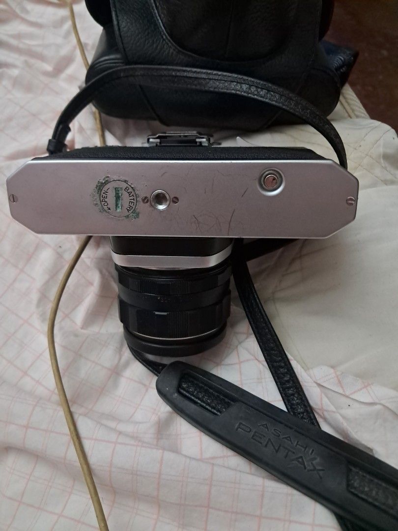 Asahi Pentax SP Film Camera (Category: Cameras) located in Davao. Submitted by rbjuvyreyn18879 (Listing ID 1439803562, Image 2). Description: - Vintage Asahi Pentax SP film camera - Silver and black body - Includes lens and camera strap - Comes with a camera case - Features aperture and focus markings on the lens - Top dial for shutter speed - Light meter dial included.