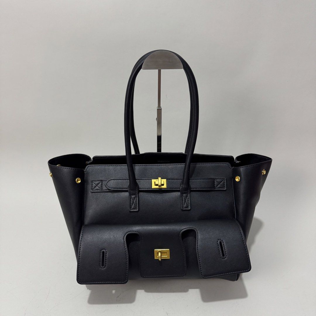 Balenciaga Black Leather Tote Bag (Category: Luxury Bags & Wallets) located in Dagupan City. Submitted by thriftygoods.dagupan (Listing ID 1439608855, Image 1). Description: - Balenciaga black leather tote bag - Structured design - Front flap pocket - Gold-tone hardware - Top handles - Made in Italy.