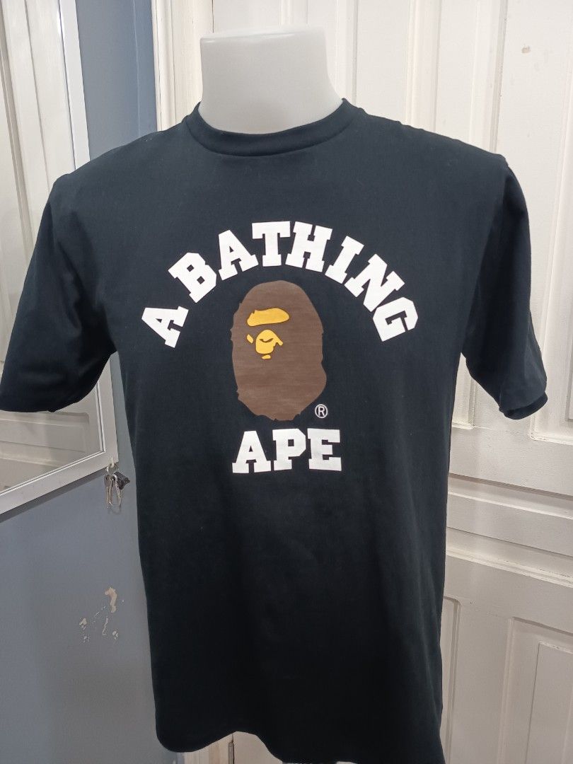 BAPE A Bathing Ape T-shirt College tee (Category: Tshirts & Polo Shirts ) located in Cagayan de Oro. Submitted by chloedime (Listing ID 1439803533, Image 1). Description: - Authentic BAPE T-shirt - Size: Large - Color: Black - Features the iconic Ape Head logo - Crew neck and short sleeves - White logo and brown Ape Head graphic - Includes original tag.