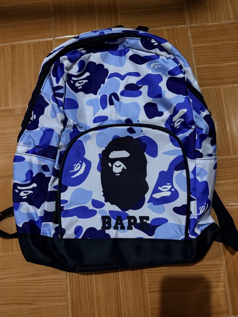 BAPE Camo Backpack (Category: Backpacks) located in Manila. Submitted by calmstar_006f69 (Listing ID 1439696047, Image 1). Description: - Authentic BAPE backpack - Eye-catching blue camouflage design - Spacious main compartment - Convenient front pocket with BAPE logo - Comfortable black back and straps - Made from durable material - Perfect for books, laptops, and daily essentials.