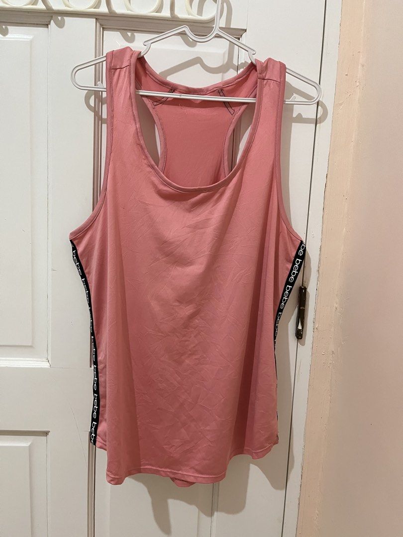 🇺🇸Free! Bebe Sport Racerback Tank top Large (Category: Activewear) located in San Pablo. Submitted by restoredchic (Listing ID 1439754574, Image 1). Description: Free for a minimum purchase of 500 pesos. Authentic bebe sport racerback tank top in a dusty rose pink shade, featuring branded “bebe” logo tape detailing running vertically down both sides. [ * Style: Athletic activewear tank top with a scoop neckline and standard racerback silhouette