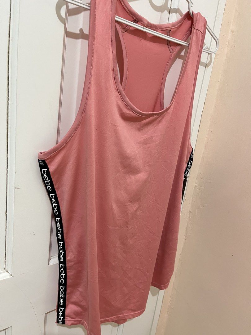🇺🇸Free! Bebe Sport Racerback Tank top Large (Category: Activewear) located in San Pablo. Submitted by restoredchic (Listing ID 1439754574, Image 2). Description: Free for a minimum purchase of 500 pesos. Authentic bebe sport racerback tank top in a dusty rose pink shade, featuring branded “bebe” logo tape detailing running vertically down both sides. [ * Style: Athletic activewear tank top with a scoop neckline and standard racerback silhouette