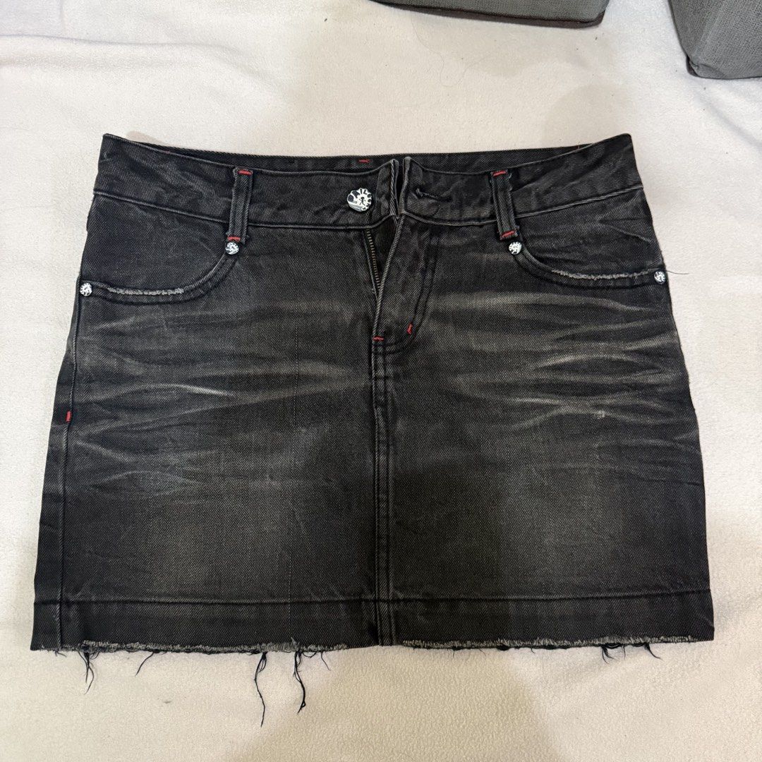 Black Denim Mini Skirt (Category: Skirts) located in Manila. Submitted by miss.v.declutter (Listing ID 1439769335, Image 1). Description: - Black denim mini skirt - Raw hem - Red stitching details - Decorative skull accents - Classic five-pocket design - Zipper closure - Slightly faded denim 📍Sampaloc, Manila.