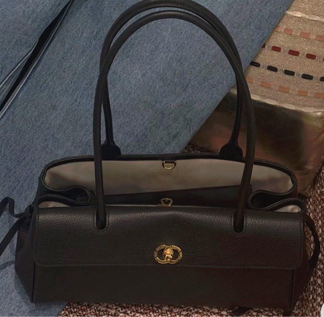 Black Leather Handbag (Category: Shoulder Bags) located in Singapore. Submitted by Jassslin72 (Listing ID 1439780892, Image 2). Description: - Elegant black leather handbag - Long handles - Spacious interior - Classic and versatile design - Drawstring detail on sides - Suitable for various occasions.