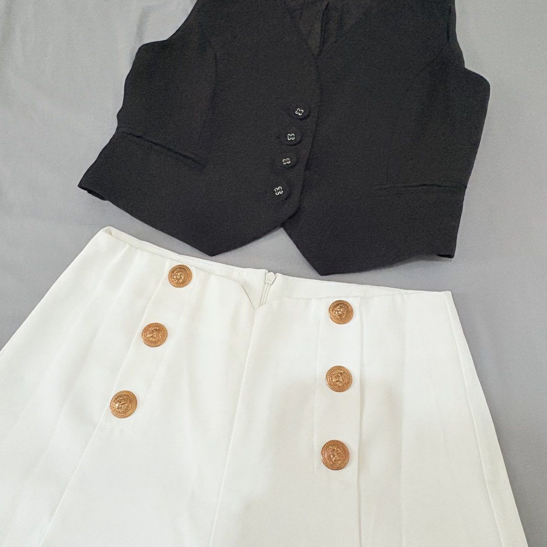 Black Vest and White Shorts Set (Category: Sets or Coordinates) located in Quezon City. Submitted by mae_iggy (Listing ID 1439698936, Image 2). Description: - Stylish black vest - Paired with high-waisted white shorts - Vest features a button-down design - Shorts have decorative buttons - Perfect for a chic and versatile look - Great for casual outings or special occasions - A fashionable wardrobe addition.