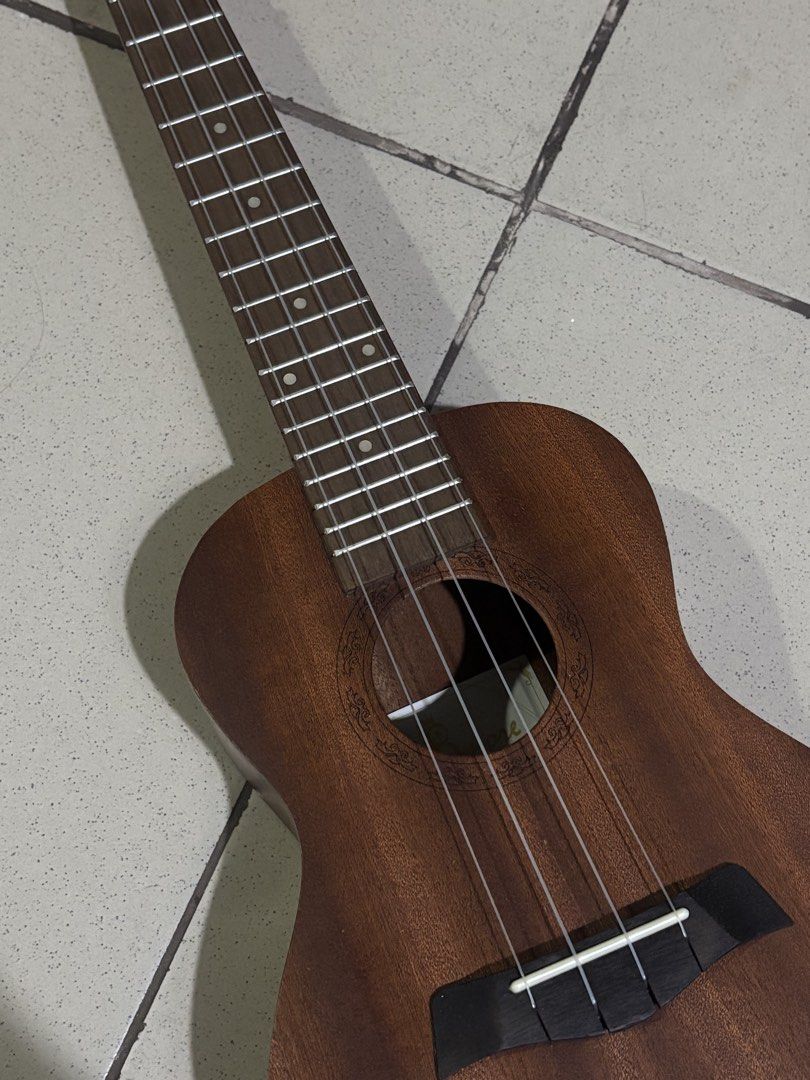 Bmore Ukulele with Aquila Strings (Category: Musical Instruments) located in Quezon City. Submitted by wizwhhahahah (Listing ID 1439630666, Image 2). Description: - Bmore ukulele with brown wooden body - Features a fretboard - Includes a black carrying case - Brand new Aquila Nylgut strings (in original packaging) - Suitable for beginners and experienced ukulele players.