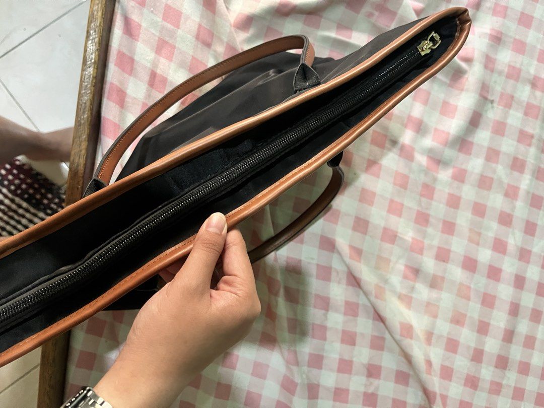 Bonstanten Bag (Category: Tote Bags) located in Manila. Submitted by lillyyy_star (Listing ID 1439736688, Image 2). Description: - Bonstanten Bag -Never been ysed - Brown leather accents - Top zipper closure - Spacious interior with multiple pockets - Includes a zippered pocket - Brown handles - Small logo on front - Durable and water-resistant material.