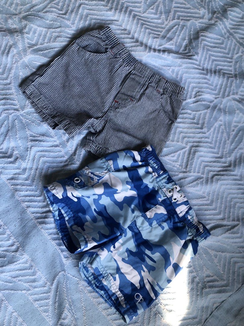 Boys' Striped and Camo Shorts (Category: Babies & Kids Fashion) located in Aliaga. Submitted by imang_13 (Listing ID 1439690155, Image 1). Description: ✅FREE FOR MINERS WHO PURCHASED 300 up ✅1-2yo - Two pairs of boys' shorts - One pair: Blue and white striped - One pair: Blue camouflage - Both have elastic waistbands - Camo shorts include a drawstring - Camo shorts feature the "OP" brand logo.