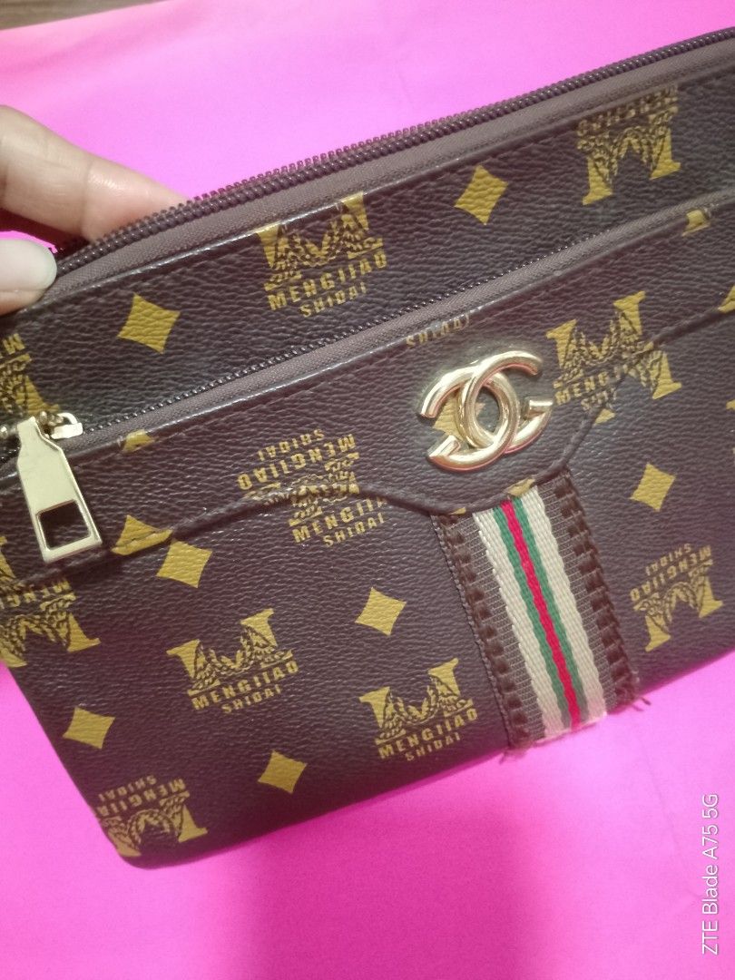 Brown Crossbody Bag/Clutch (Category: Cross-body Bags) located in Binan City. Submitted by criscb (Listing ID 1439646747, Image 3). Description: * Monogram print with multiple zipper compartments. Note: The sling/strap has some slight damage (reflected in the low price!), but it can easily be used as a clutch or swapped out with any standard clip-on strap you already own. * With front & back zipper.