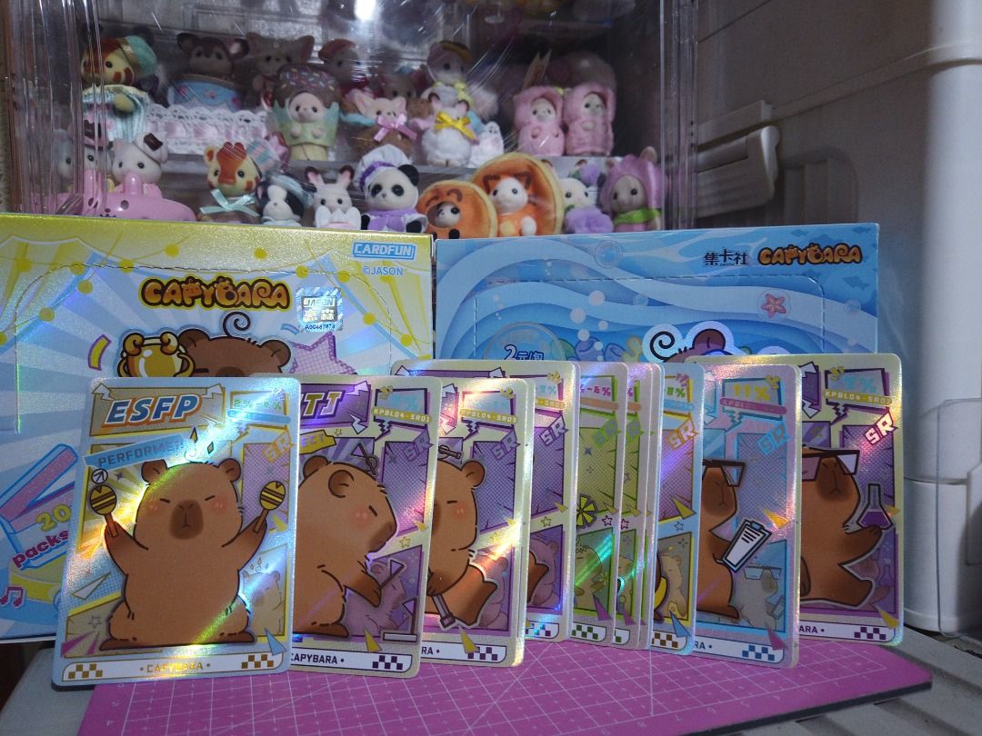 Capybara Trading Cards (Category: Raw Singles) located in Quezon City. Submitted by angie_bells (Listing ID 1439797394, Image 3). Description: - Capybara trading cards total of 145 PCS - Includes various designs and styles - Some cards feature holographic effects - Always stored in boxes (Bough every card/pack at CO. the collectible store for PHP 20 per pack with 4 cards) 📍QC | Shipping via Lalamove/Grab/JNT (buyer shoulders sf) • Maya/GCash/Mar