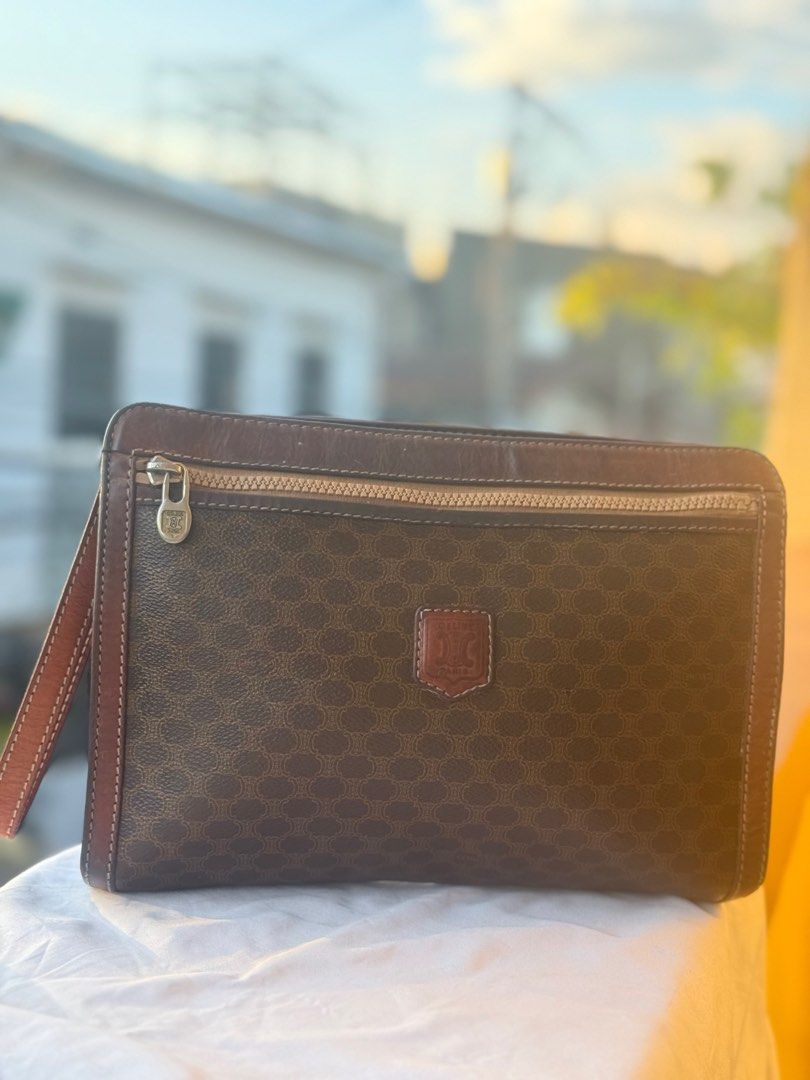 CELINE MACADAM VINTAGE CLUTCH BAG (Category: Luxury Bags & Wallets) located in Paranaque City. Submitted by lyn0618 (Listing ID 1439738935, Image 1). Description: FOR SALE! AUTHENTIC. CELINE VINTAGE. MACADAM. LEATHER CLUTCH BAG PRE LOVED ITEM. ISSUE: SOME LEATHER TRIMMINGS BROWN LIGHTEN .DUE TO ITS. USAGE. Still USABLE . GOOD CORNERS AND SIDES AND BASE SEE PHOTO. NO. OPEN PIPES. NO TRANSFER. ORIGINAL CELINE ZIPPER PULLER SEE PHOTOS LEATHER. STRAP