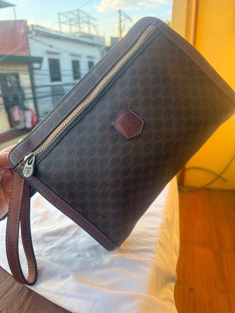 CELINE MACADAM VINTAGE CLUTCH BAG (Category: Luxury Bags & Wallets) located in Paranaque City. Submitted by lyn0618 (Listing ID 1439738935, Image 2). Description: FOR SALE! AUTHENTIC. CELINE VINTAGE. MACADAM. LEATHER CLUTCH BAG PRE LOVED ITEM. ISSUE: SOME LEATHER TRIMMINGS BROWN LIGHTEN .DUE TO ITS. USAGE. Still USABLE . GOOD CORNERS AND SIDES AND BASE SEE PHOTO. NO. OPEN PIPES. NO TRANSFER. ORIGINAL CELINE ZIPPER PULLER SEE PHOTOS LEATHER. STRAP