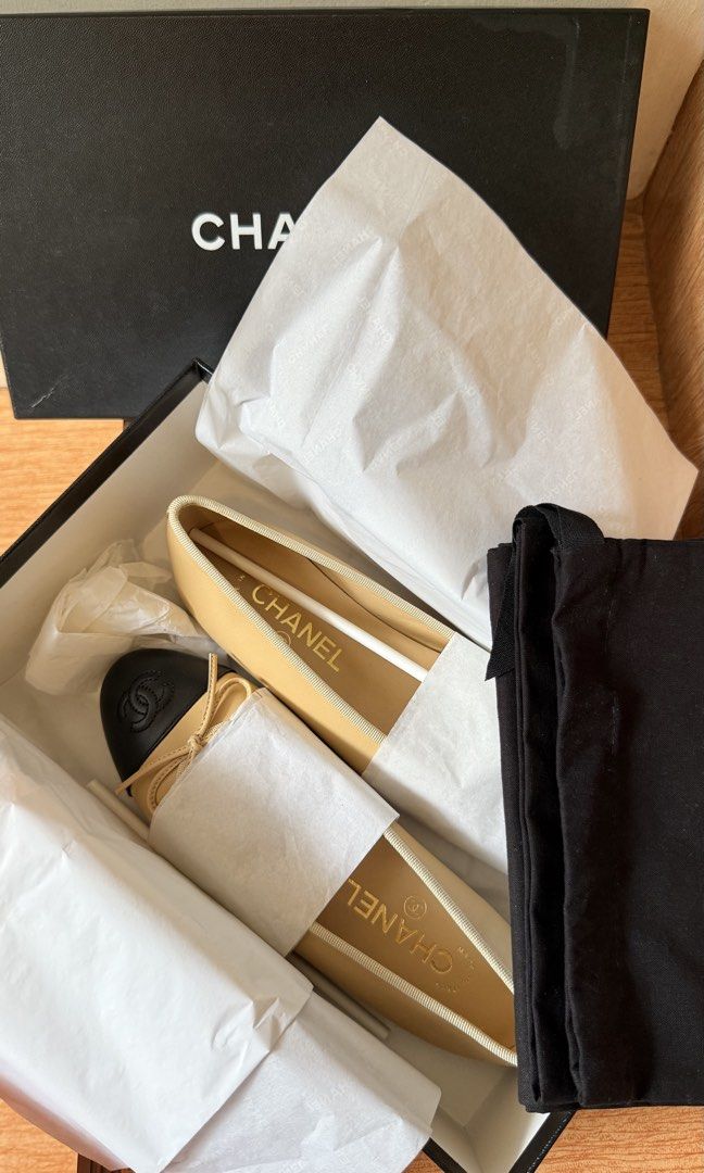 Chanel Ballerina Flats (Category: Sneakers & Footwear) located in Malolos. Submitted by flapnbloom.ph (Listing ID 1439701311, Image 2). Description: - Authentic Chanel ballerina flats - Cap-toe design with Chanel logo - Beige and black colorway - Includes original box and dust bag - Size EUR 36.5 - Made in Italy.